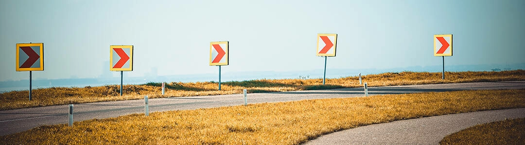  2021/10/Curve_Header.jpg Road signs warning drivers about ahead dangerous curve