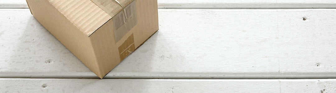  2021/10/box-front-porch-1080.jpg Cardboard delivery parcel box delivered to doorstep closeup