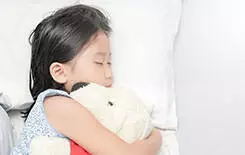  2021/10/child-in-bed-245.jpg cute little asian girl sleep and hug doll on bed in the bedroom., top view