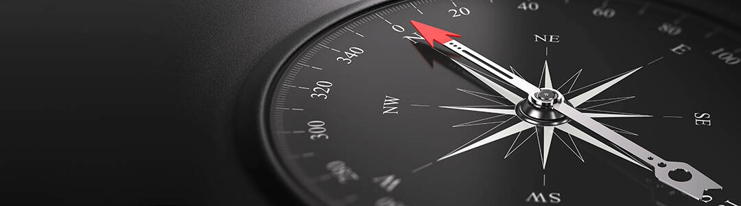  2021/10/envato-compass-1080.jpg 3D illustration of a compass over black background with needle pointing the north direction, free space on the left side of the image. Business orientation concept.
