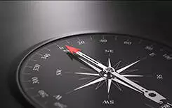  2021/10/envato-compass-245.jpg 3D illustration of a compass over black background with needle pointing the north direction, free space on the left side of the image. Business orientation concept.