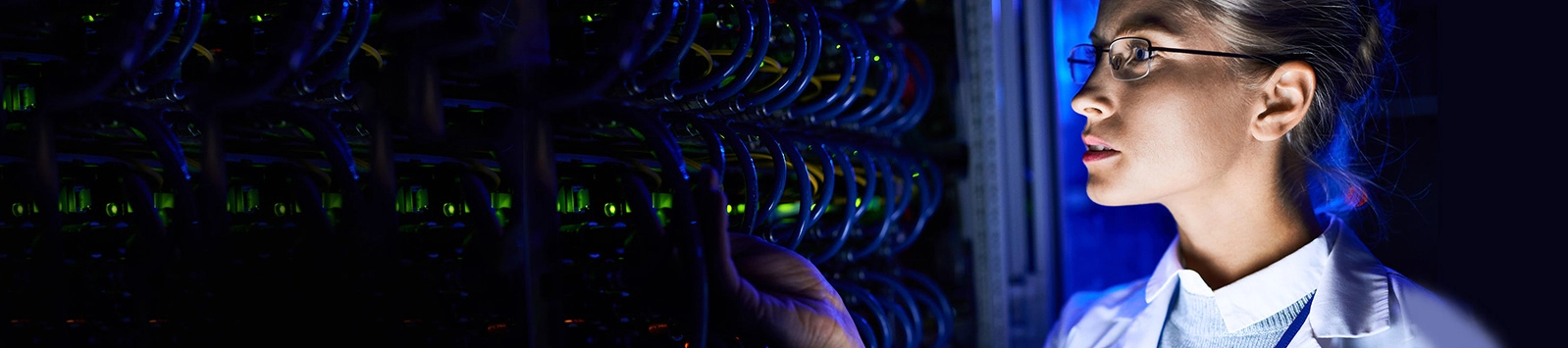 person checking blade servers in neon light
