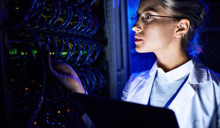 person checking blade servers in neon light