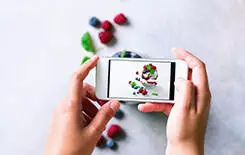  2021/10/girl-is-taking-photos-of-breakfast-245.jpg Girl is taking photos of breakfast, chia pudding with berries to mobile phone. Social media, instagram concept. Copy space, top view