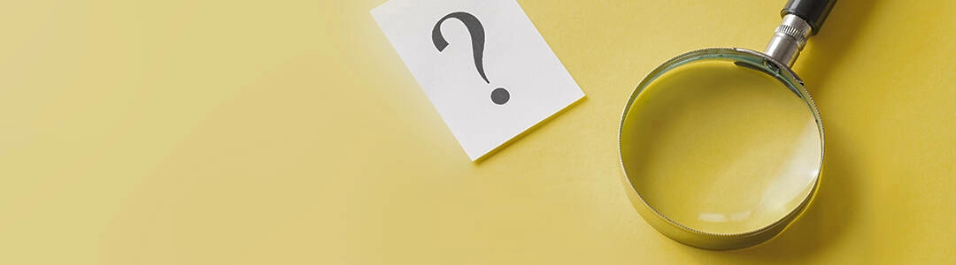  2021/10/magnifying-glass-question-mark-1080.jpg Magnifying glass with printed question mark lying side by side on a yellow background in a conceptual image viewed from above