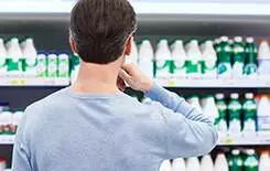  2021/10/man-choosing-product-245.jpg Man chooses dairy products in the store