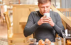  2021/10/man-coffee-cafe-smell-245.jpg Inspired by cup of fresh coffee. Handsome young man enjoying coffee in cafe while sitting at the table and smelling coffee aroma