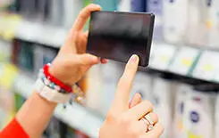  2021/10/woman-taking-picture-smartphone-supermarket-245.jpg Woman taking picture in supermarket