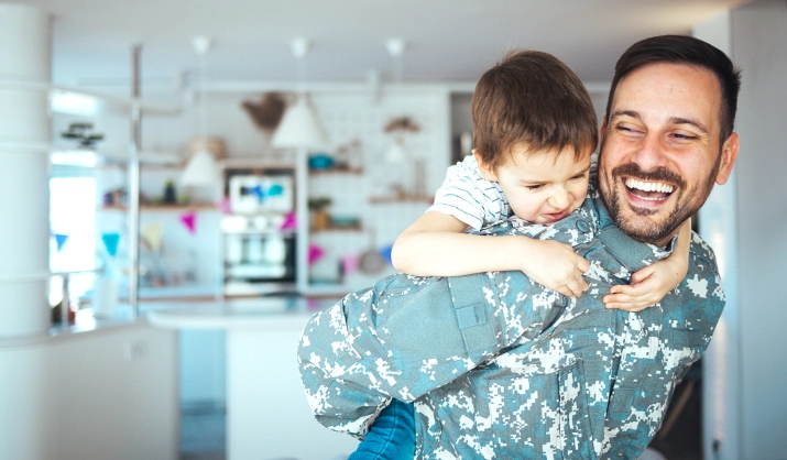 Military father hugs son