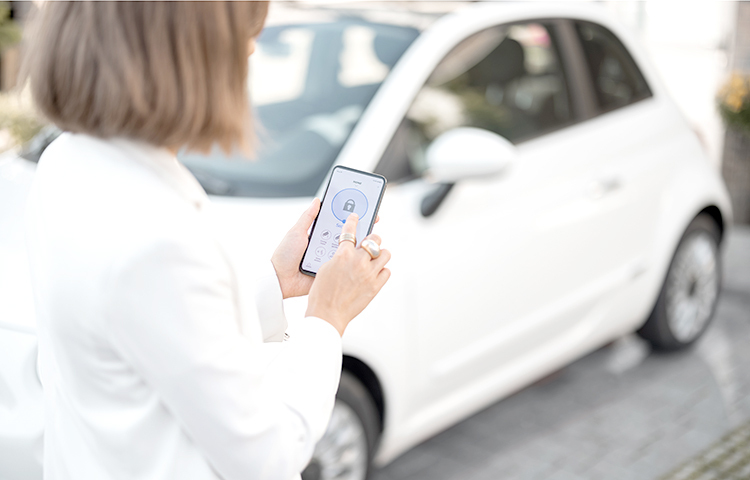 Woman control car alarm with mobile phone