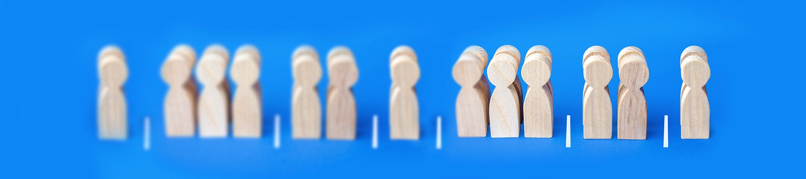 Wooden figures separated into groups