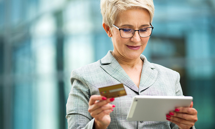 Woman with tablet and credit card