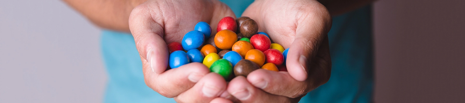 Male hands holding colored candies