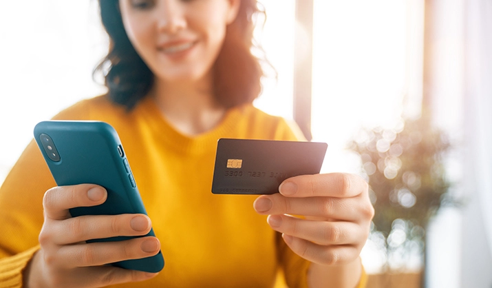 woman with a phone and credit card