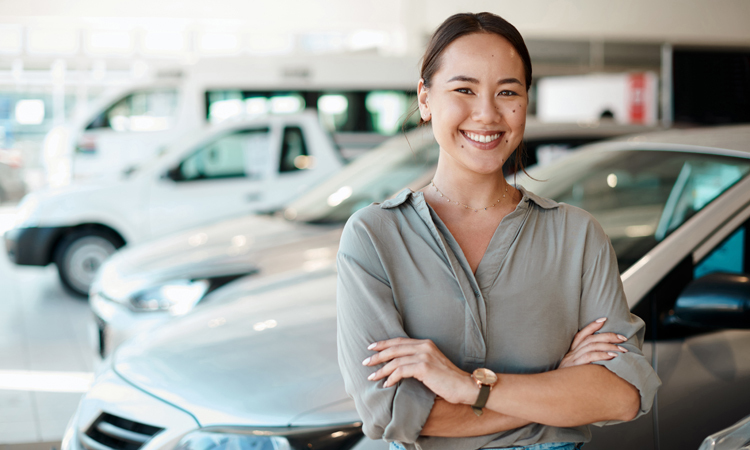 happy woman at a car dealership