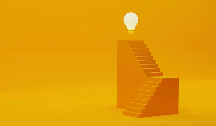 Illustration of a steep stairway leading to bright lightbulb