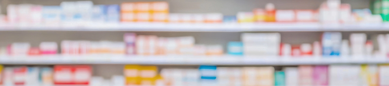 blurry view of pharmacy shelf filled with products