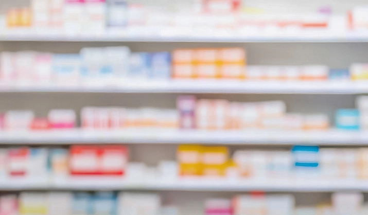 blurry view of pharmacy shelf filled with products