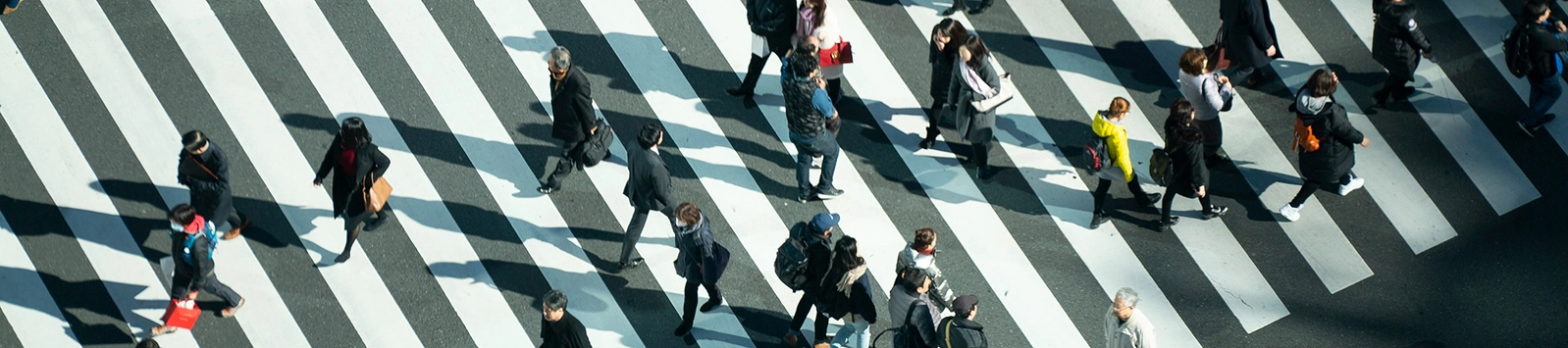 People crossing the street in a busy crosswalk