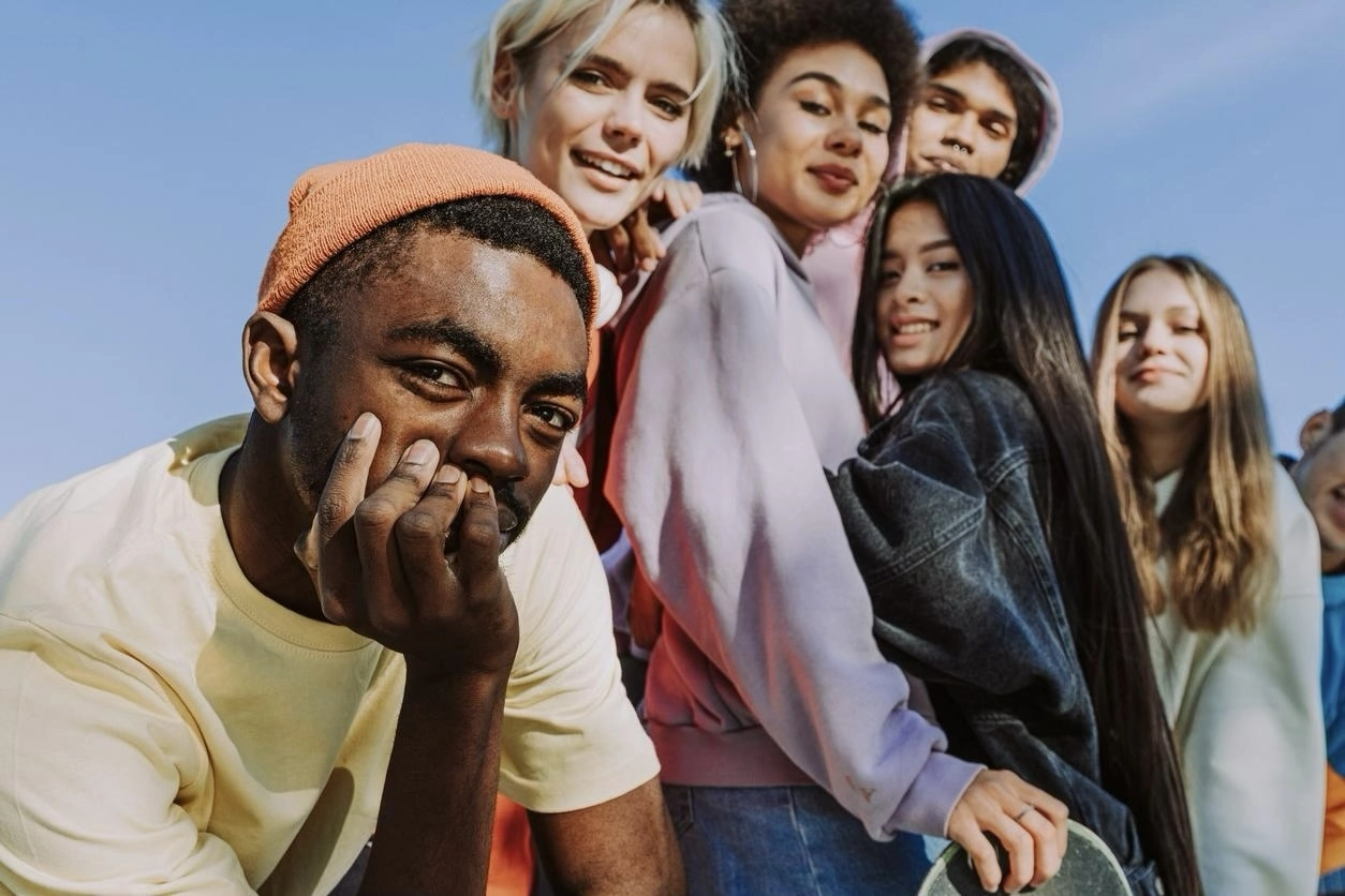A group of young adult friends looking sidelong at the camera.